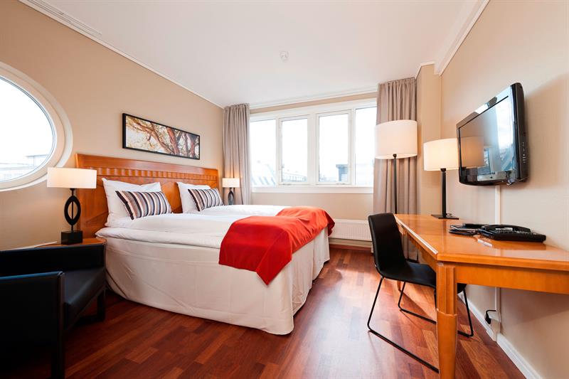 Rom med dobbeltseng og skrivebord på First Hotel Millenium