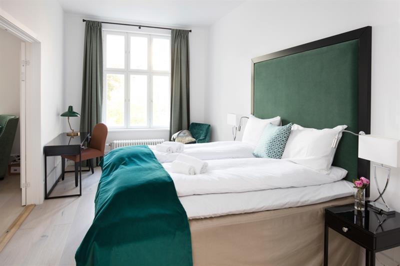 Soverom i grønt i Frogner House Apartments.
