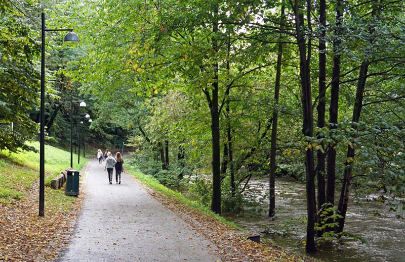People walking alongside the river.