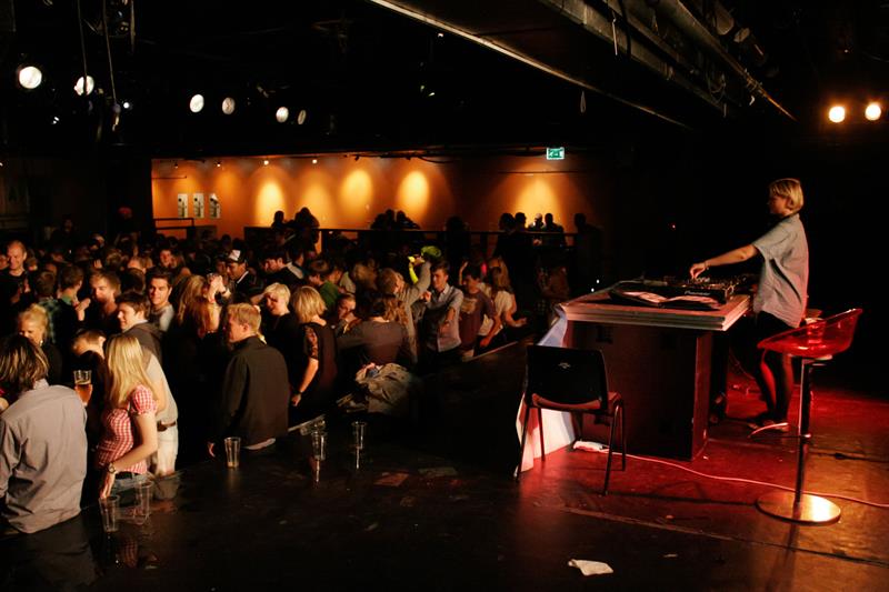 A DJ playing music for a packed audience.
