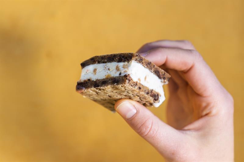 noen som holder et iskremsmørbrød