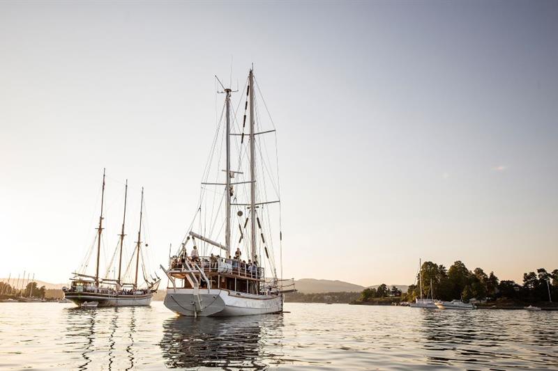 Nyt deilig mat og drikke på middagscruiset mens solen går ned i havet