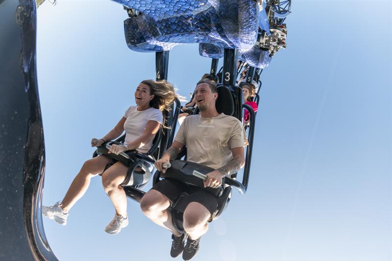 People hanging upside down from a rollercoaster